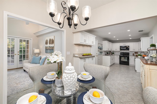 dining space with french doors and an inviting chandelier