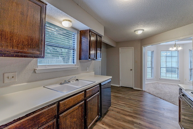 kitchen with dark brown cabinetry, sink, hardwood / wood-style flooring, dishwasher, and a chandelier