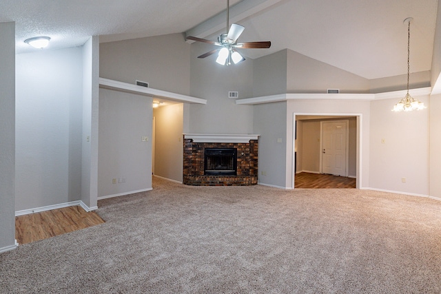 unfurnished living room featuring a brick fireplace, ceiling fan with notable chandelier, beam ceiling, high vaulted ceiling, and carpet floors