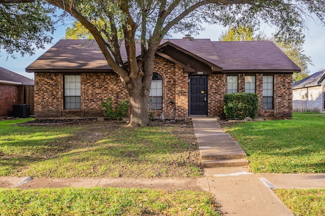 view of front of property featuring a front yard and central air condition unit