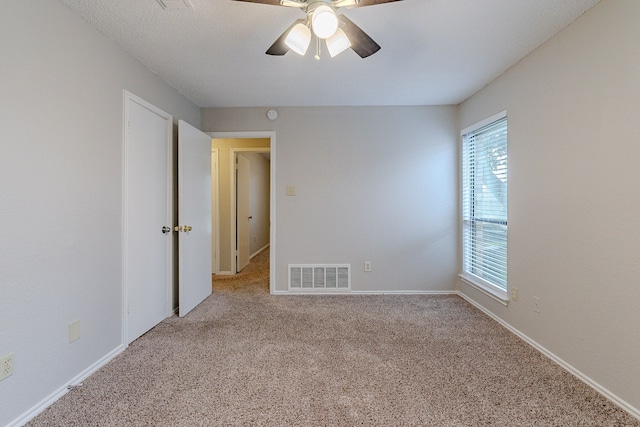 spare room with light carpet and ceiling fan