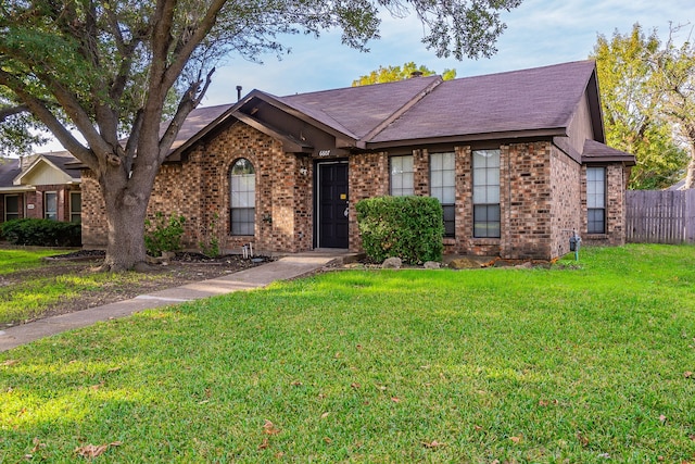 single story home featuring a front yard