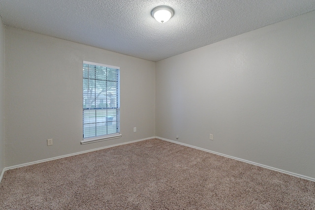 unfurnished room featuring carpet and a textured ceiling