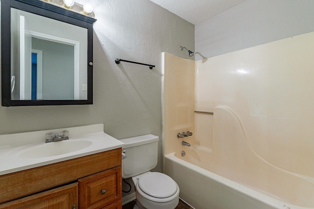 full bathroom featuring vanity, toilet, a textured ceiling, and shower / washtub combination