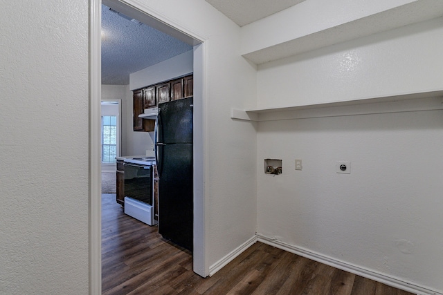 clothes washing area featuring hookup for an electric dryer, dark hardwood / wood-style floors, a textured ceiling, and hookup for a washing machine