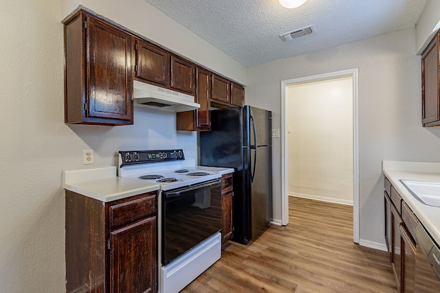 kitchen featuring dark brown cabinets, a textured ceiling, black refrigerator, electric stove, and light hardwood / wood-style floors