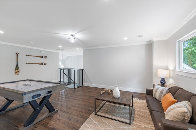 recreation room featuring ornamental molding and hardwood / wood-style flooring