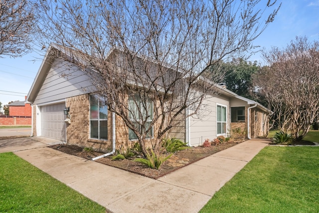 view of front of property featuring a garage and a front lawn