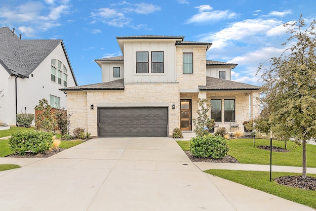 view of front of home featuring a garage and a front lawn