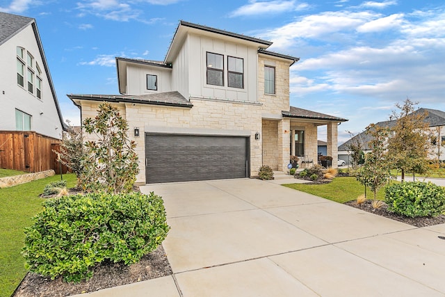 view of front of property featuring a front yard and a garage