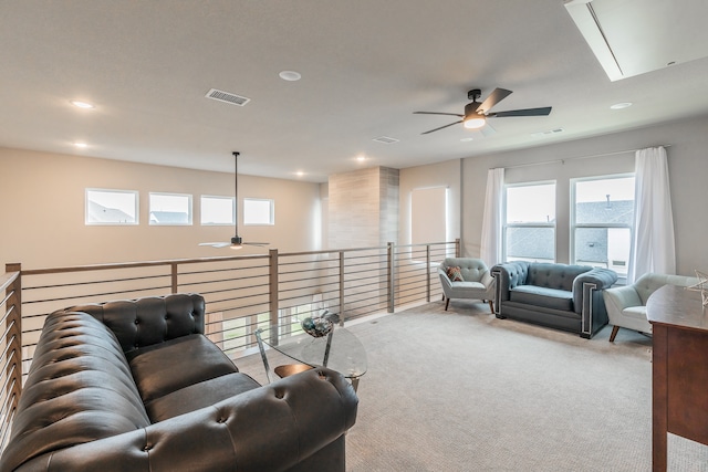 carpeted living room featuring ceiling fan