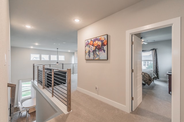 hallway with light colored carpet