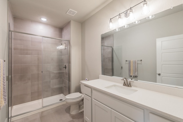 bathroom with tile patterned floors, vanity, toilet, and an enclosed shower