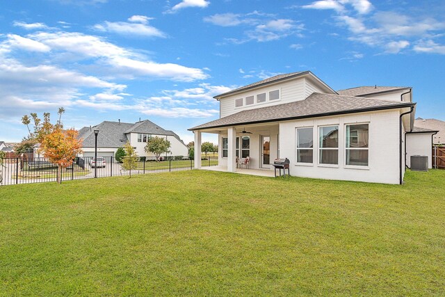 back of property featuring central AC unit, ceiling fan, a yard, and a patio