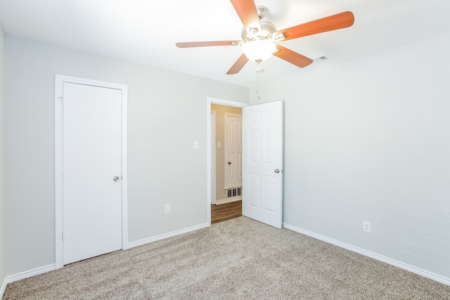 unfurnished bedroom featuring light carpet and ceiling fan