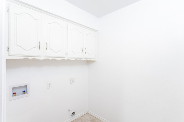 laundry area with washer hookup, electric dryer hookup, light tile patterned flooring, and cabinets