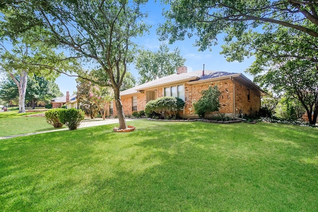 603 Lake Meadows Dr, Rockwall, TX 75087 - ranch-style house featuring brick siding, a chimney, and a front yard