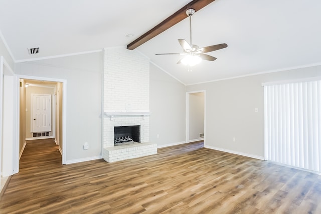 unfurnished living room with lofted ceiling with beams, a brick fireplace, hardwood / wood-style flooring, and ceiling fan