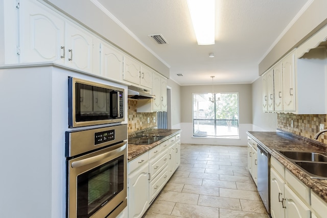 kitchen with appliances with stainless steel finishes, tasteful backsplash, white cabinetry, and sink