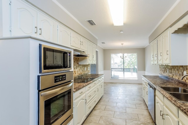 603 Lake Meadows Dr, Rockwall, TX 75087 - kitchen with appliances with stainless steel finishes, dark countertops, backsplash, white cabinets, and ornamental molding