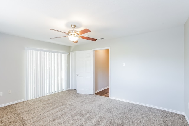 unfurnished bedroom featuring ceiling fan and dark carpet