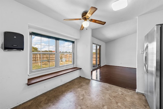 spare room with concrete flooring, ceiling fan, and lofted ceiling