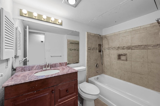 full bathroom with vanity, tiled shower / bath combo, and toilet