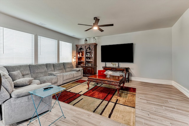 living room with ceiling fan and light hardwood / wood-style floors