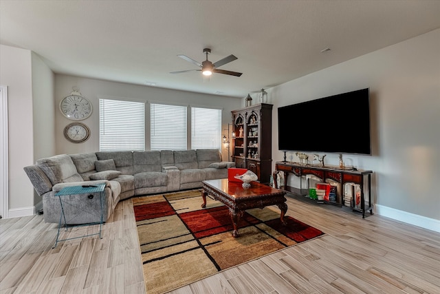 living room featuring ceiling fan and light hardwood / wood-style flooring