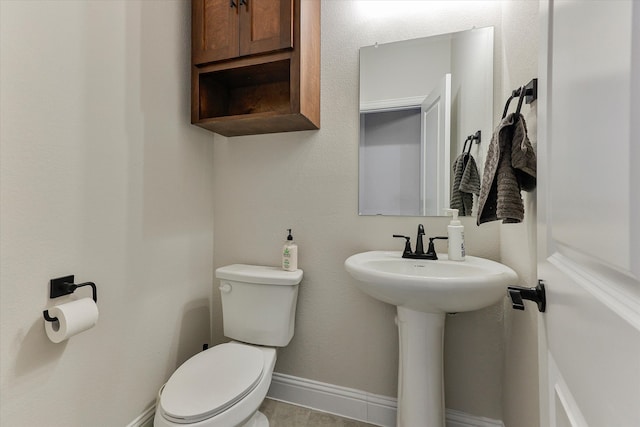 bathroom featuring sink, tile patterned flooring, and toilet