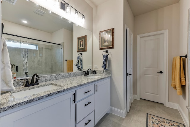 bathroom with tile patterned floors, vanity, and a shower with shower door