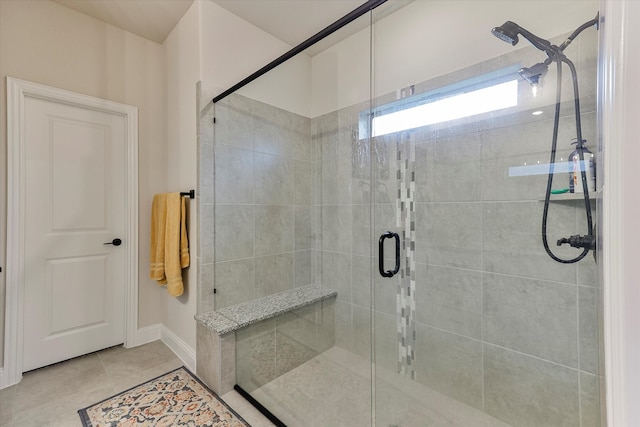 bathroom with tile patterned floors and an enclosed shower