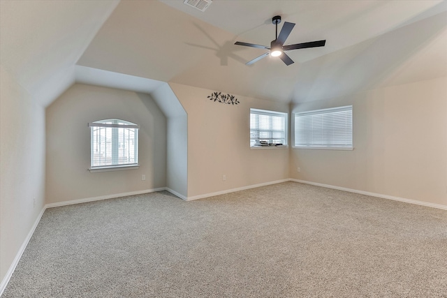 additional living space with ceiling fan, light carpet, and vaulted ceiling