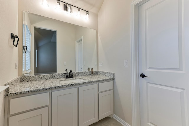 bathroom with vanity and vaulted ceiling