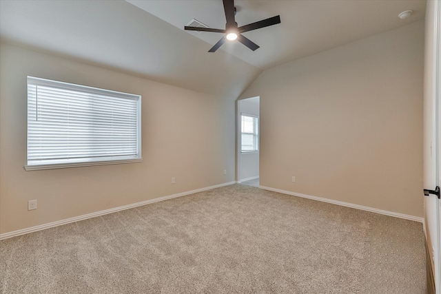 unfurnished room featuring ceiling fan, light colored carpet, and vaulted ceiling