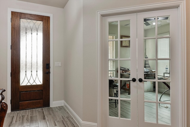 entryway featuring light wood-type flooring and french doors