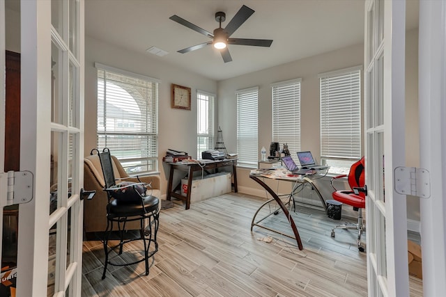 office space with ceiling fan, light hardwood / wood-style flooring, and french doors