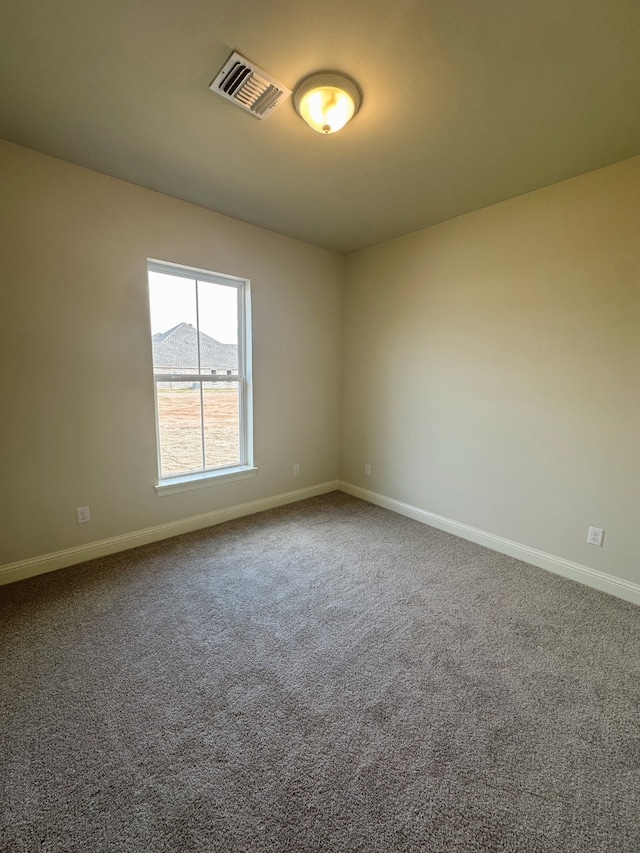 carpeted spare room with baseboards, visible vents, and a mountain view