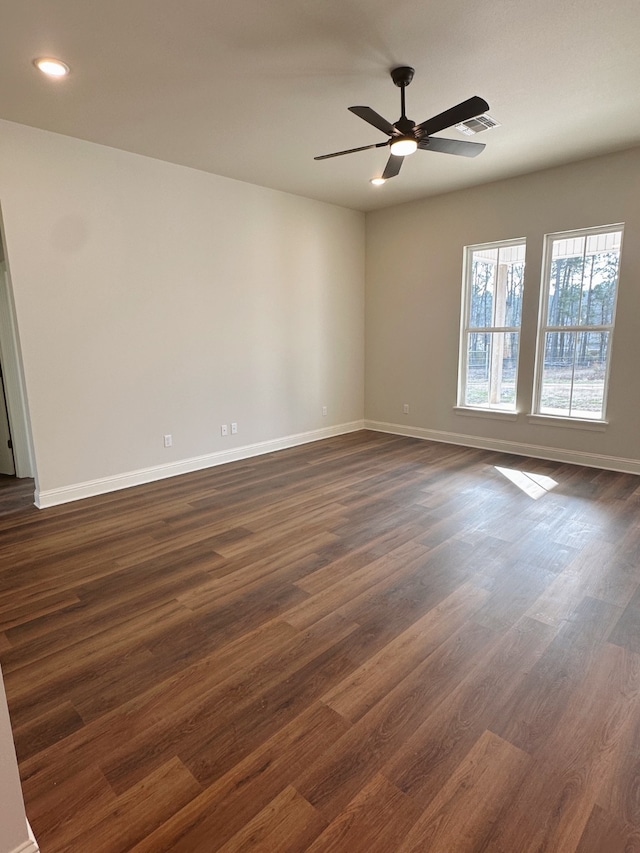 empty room with dark hardwood / wood-style floors and ceiling fan