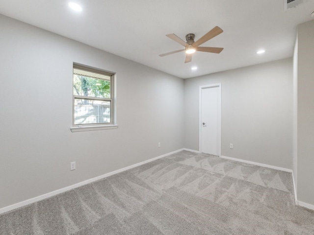 carpeted spare room featuring ceiling fan