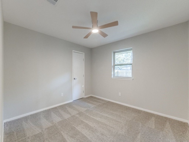 carpeted spare room with ceiling fan