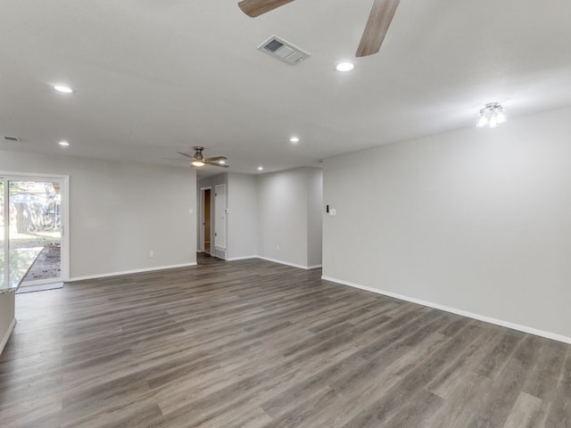 spare room with ceiling fan and dark wood-type flooring