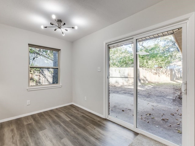 interior space featuring dark hardwood / wood-style flooring, plenty of natural light, and a chandelier