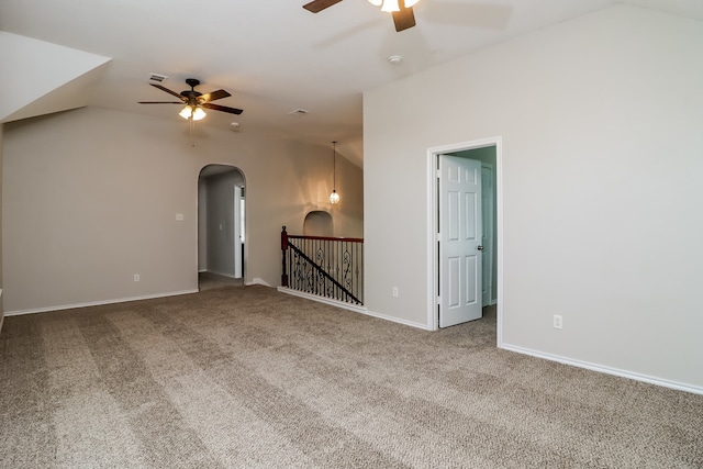 carpeted spare room with ceiling fan and vaulted ceiling