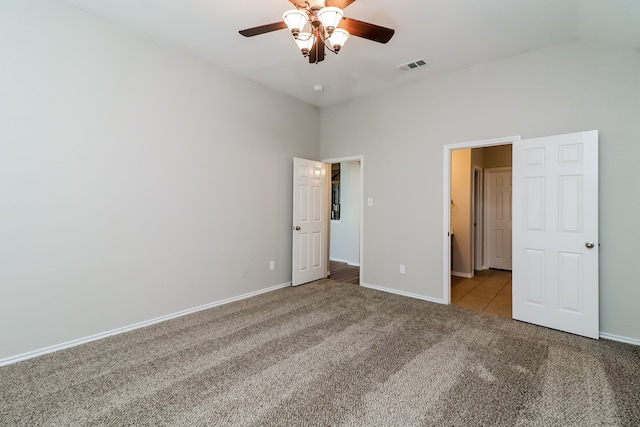 unfurnished bedroom featuring ceiling fan, light colored carpet, and lofted ceiling