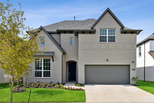 view of front of home featuring a garage and a front yard