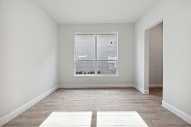 spare room featuring light hardwood / wood-style floors