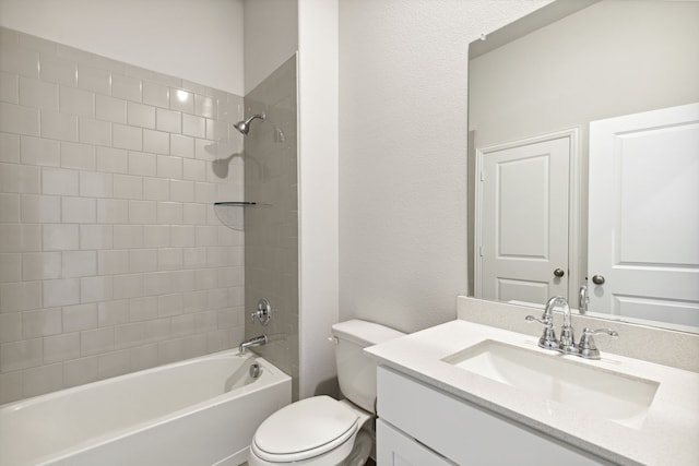 full bathroom with vanity, tiled shower / bath combo, and toilet