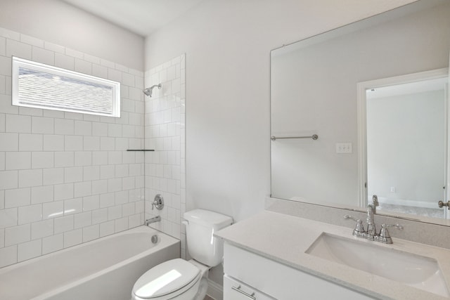 full bathroom featuring tiled shower / bath combo, vanity, and toilet