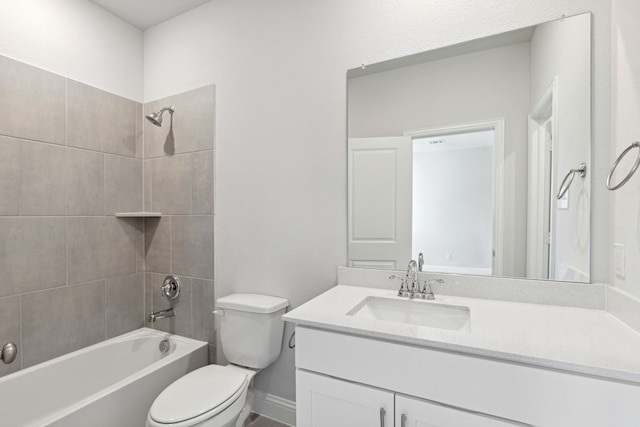 full bathroom with vanity, tiled shower / bath combo, and toilet